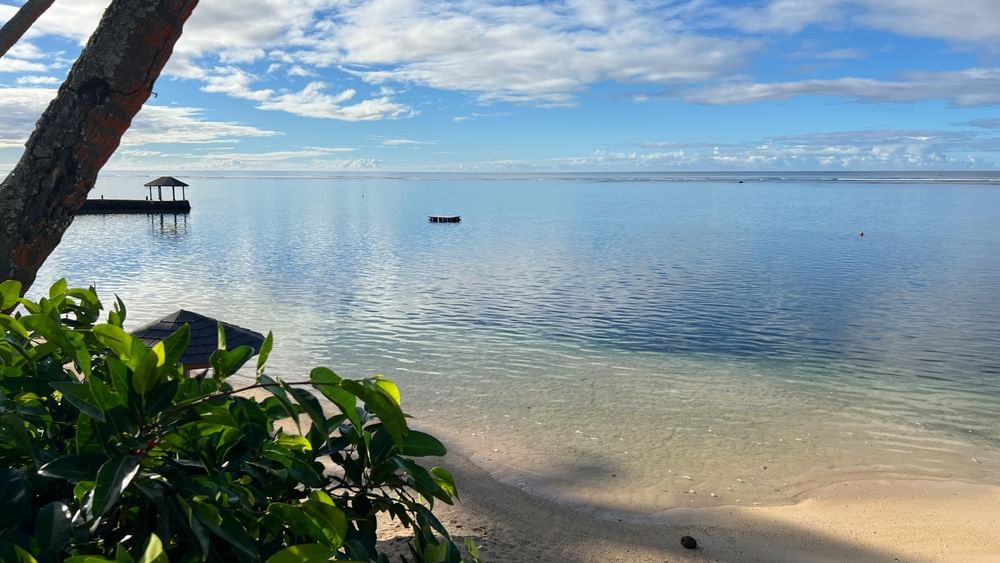 Sandy beach view with blue ocean and clear sky at Warwick Fiji Resort and Spa, Korolevu.