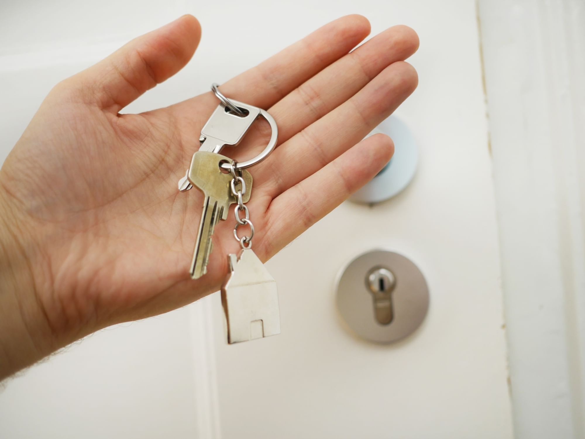 A person holding a room key at Rheinland Hotel Kollektion