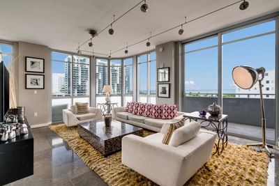 living room with sofas and floor to ceiling windows