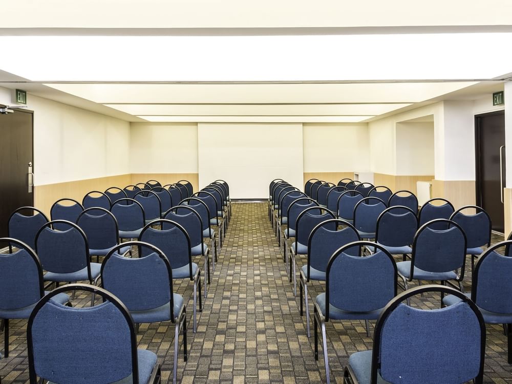Back shot of arranged chairs at an event in Fiesta Inn Hotels