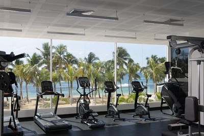 Exercise machines in the gym with sea view at Club Hemingway