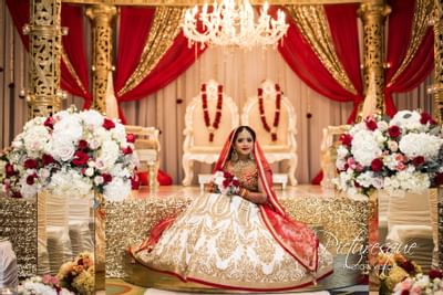 indian bride sitting on gold altar
