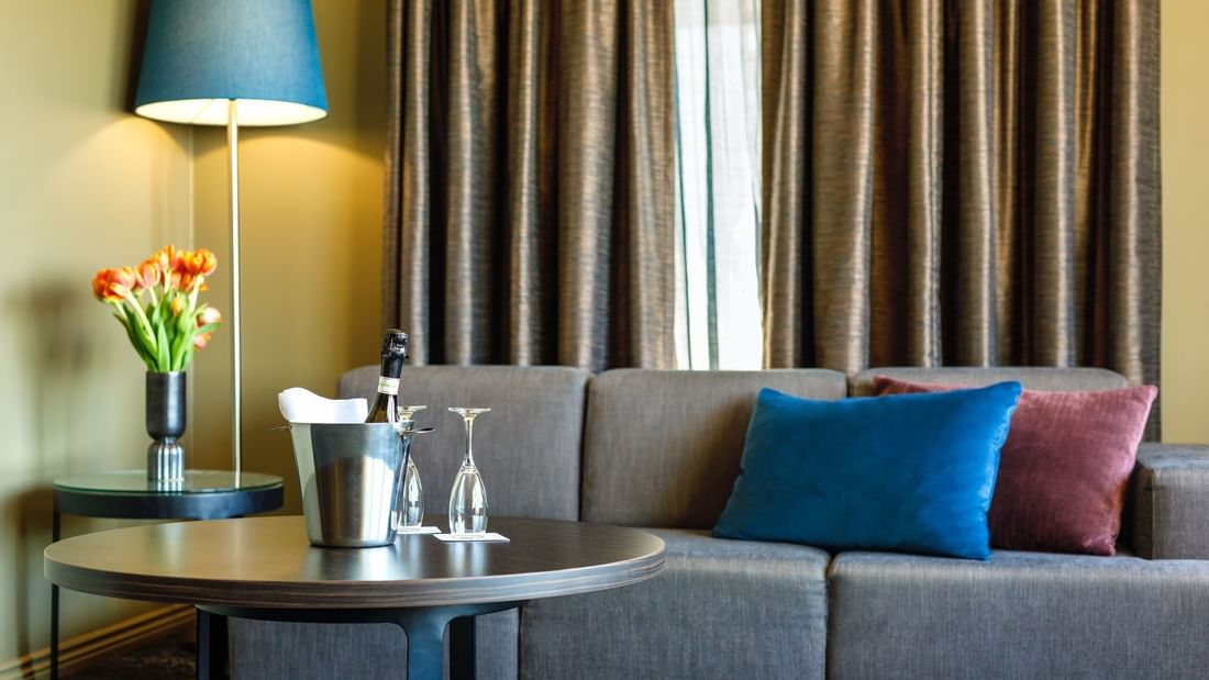 Lamp & champagne bucket by the sofa in Junior Suite at Pullman Sydney Hyde Park