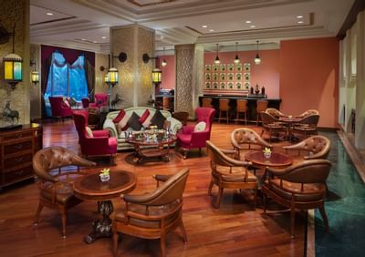 Lounging area with chairs and tables at Hotel Ajman
