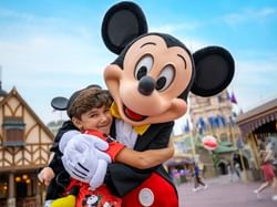 Boy & Mickey mouse in Disney World near Rosen Inn Lake Buena Vista