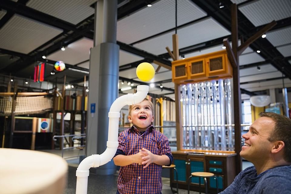 A kid amazed by an exhibit in Telus Spark Kids Museum near Acclaim Hotel Calgary