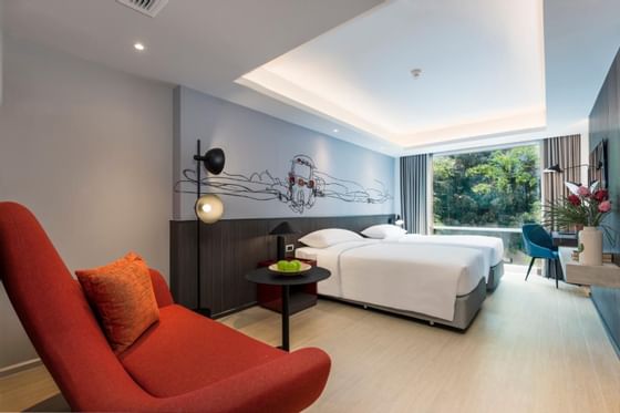 Bed & working area in Standard at Maitria Hotel Rama 9 Bangkok