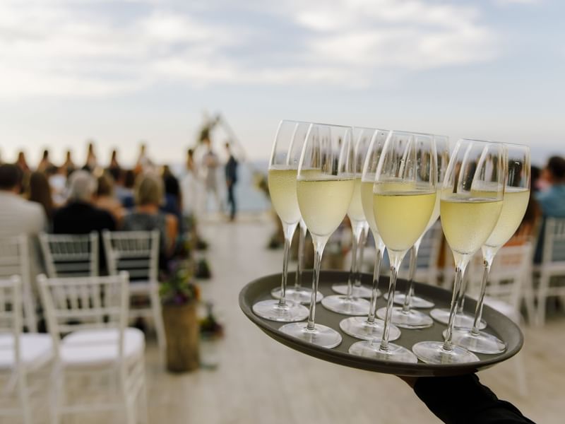 Close-up of holding champagne glasses to serve in a wedding ceremony at Live Aqua Cancún