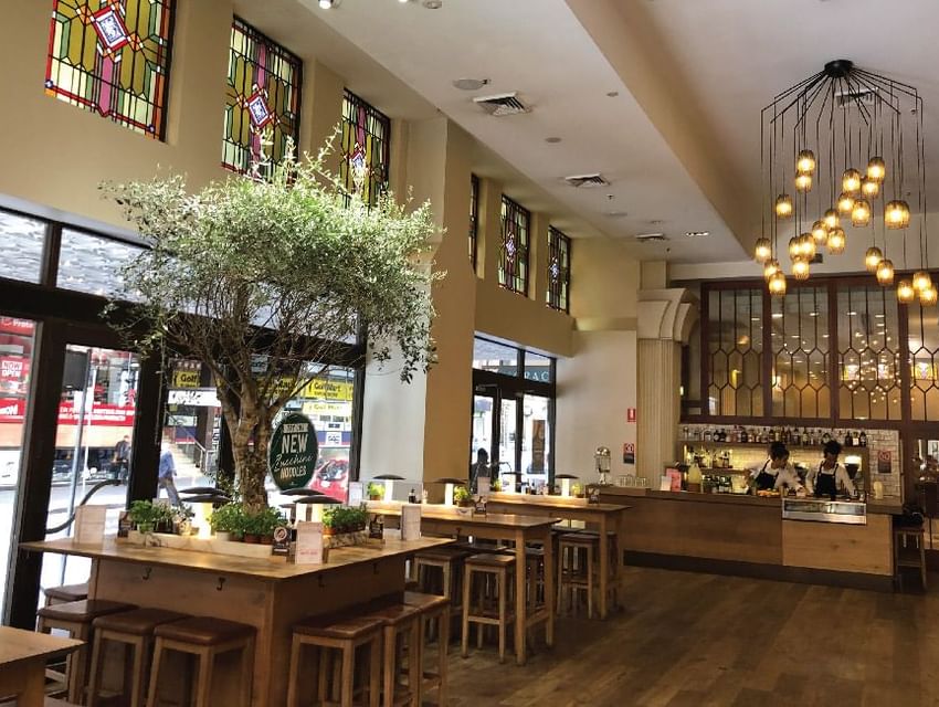 Mini tree, ceiling lights & wooden floor decor in the Restaurant at The Grace Sydney