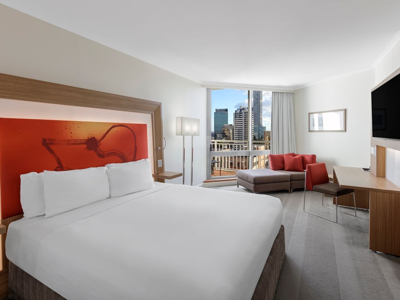Bed with window view in Premier Double King Room at Amora Hotel