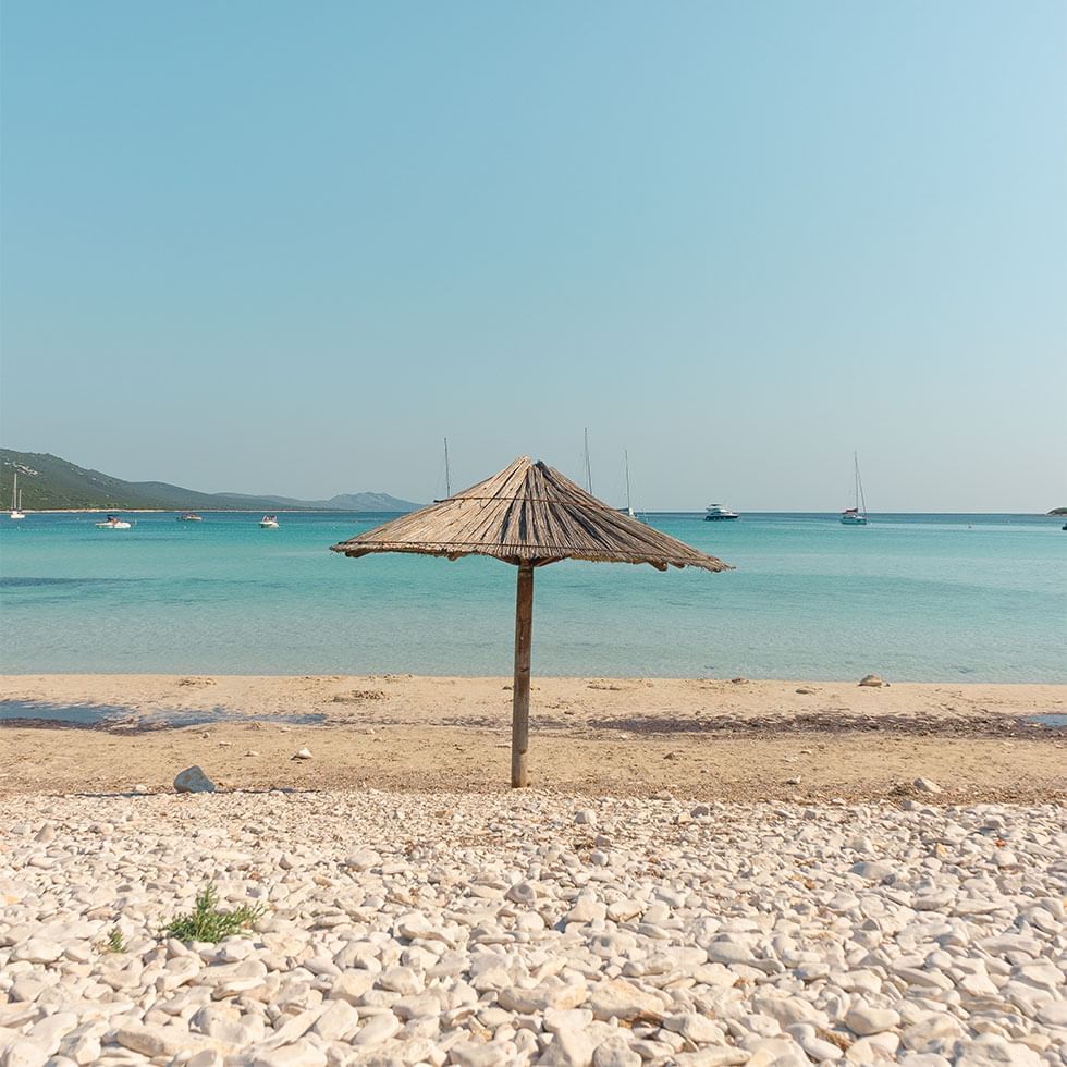 Thatch umbrella at Pag Island's beach near Falkensteiner Hotels