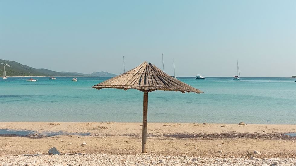 Thatch umbrella at Pag Island's beach near Falkensteiner Hotels