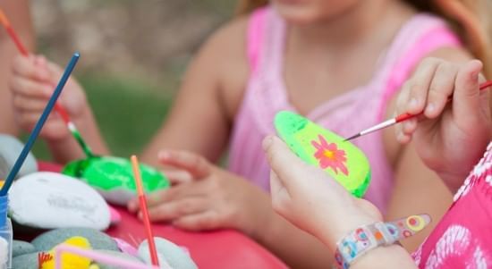 Kids engaged in painting stones at The Somerset on Grace Bay