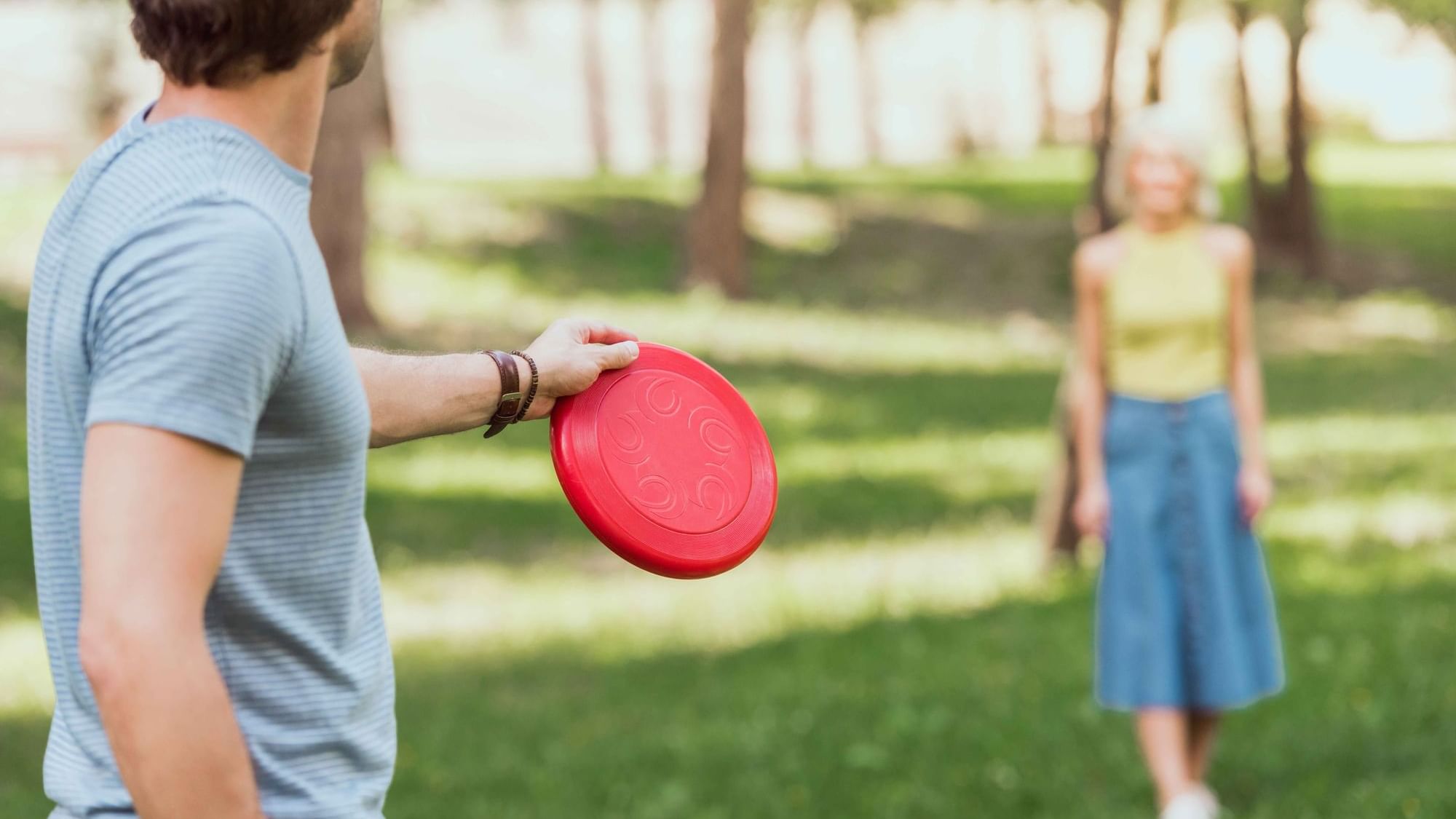 Couple playing frisbee in the garden with a flying disc at Cove Pocono Resorts