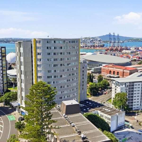 Aerial view of urban skyline and waterfront at Student Living Auckland - Beach.