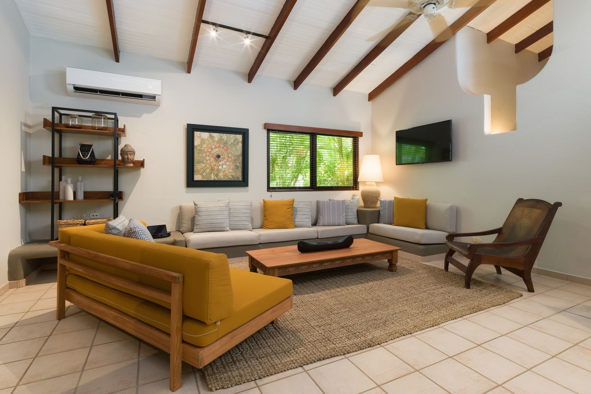 Villa 2 Bedrooms with Private Pool featuring mustard sofas, a wooden table, and tropical views at Cala Luna Boutique Hotel