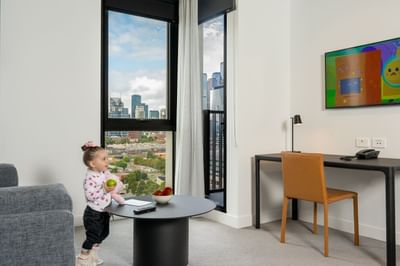 Kid watching television in the Livingroom at Nesuto Docklands