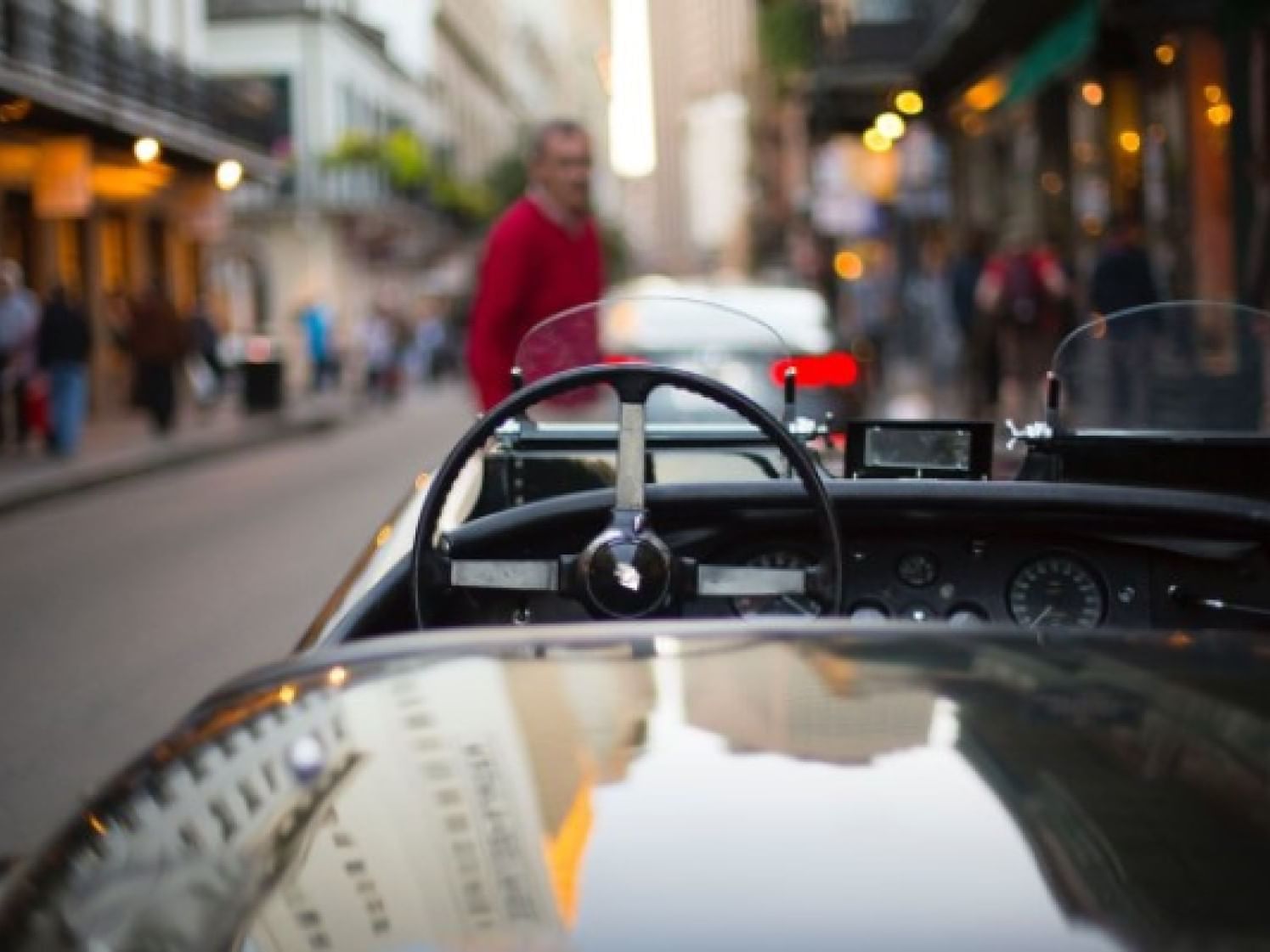 A closeup picture of a convertible car in the streets
