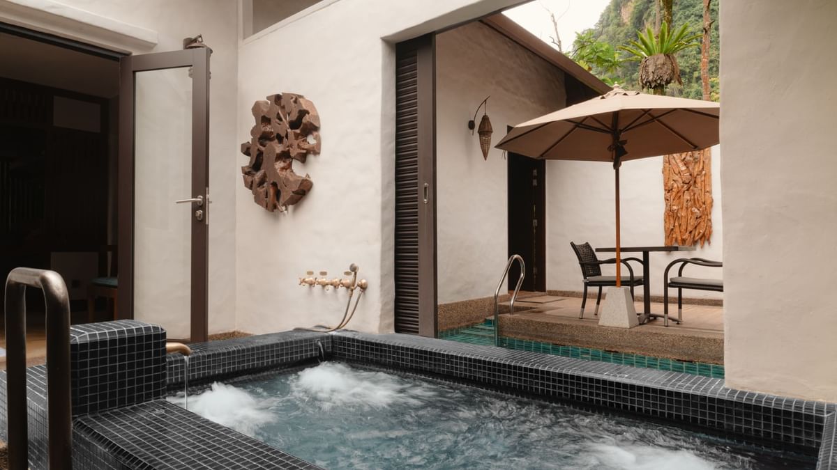 Hot spring pool in Water Villa with outdoor seating at The Banjaran Hotsprings Retreat