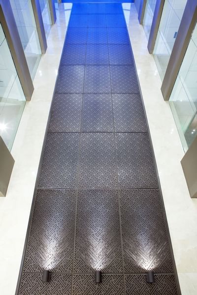 a walkway with silver tiles