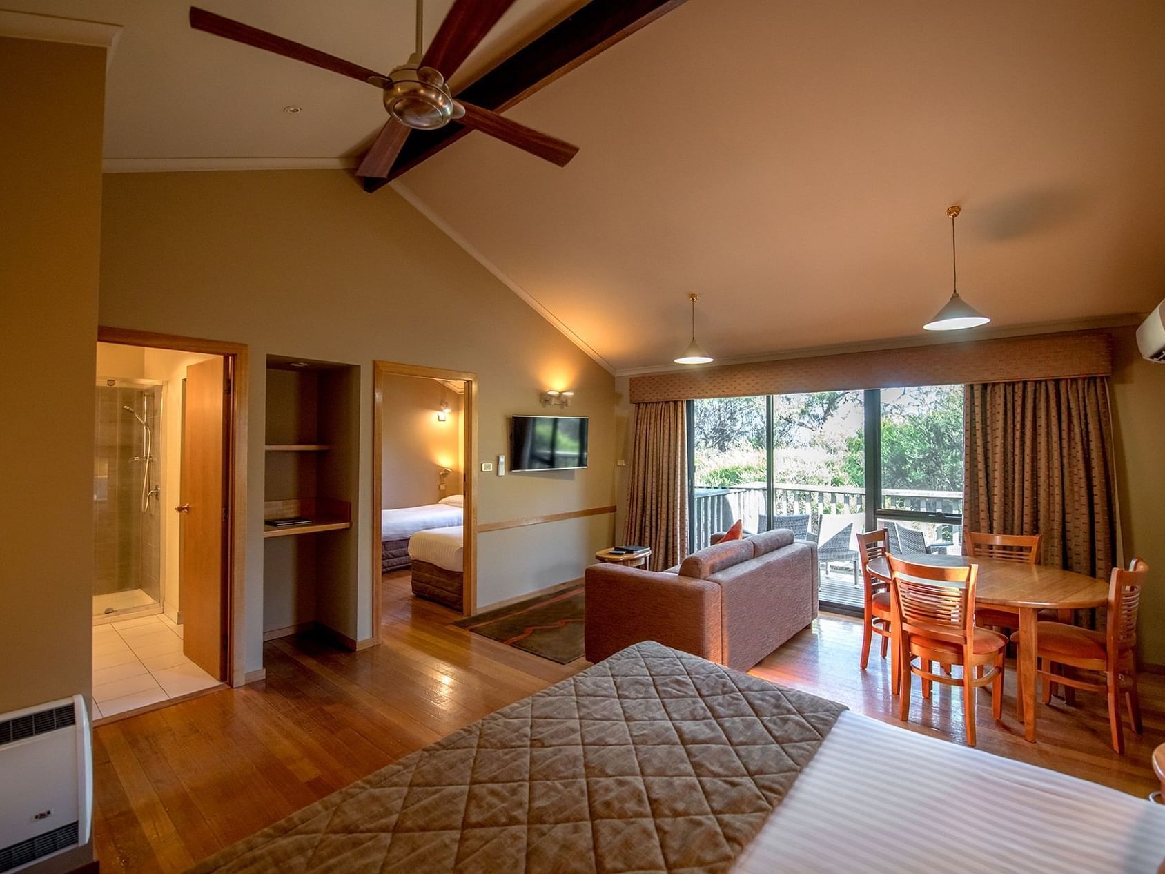 Lounge area by the bed in Family cabin with wooden floors at Freycinet Lodge