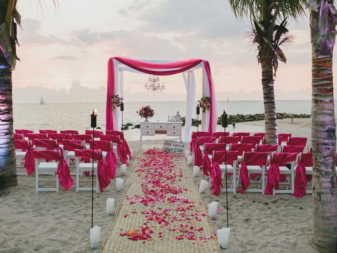 Aisle with flowers at a beach wedding near La Colección Resorts