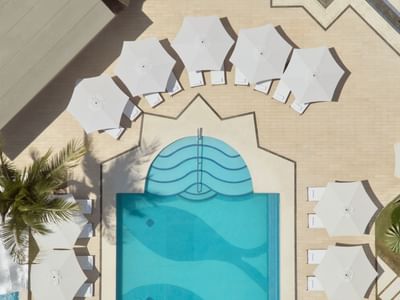 Aerial view of outdoor pool area and lounges with umbrellas at Villa Premiere Boutique Hotel & Romantic Getaway