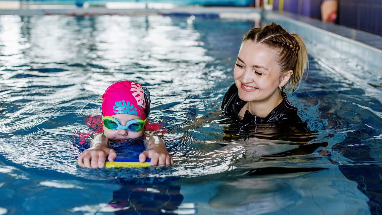 A woman and a child in swimming in a pool