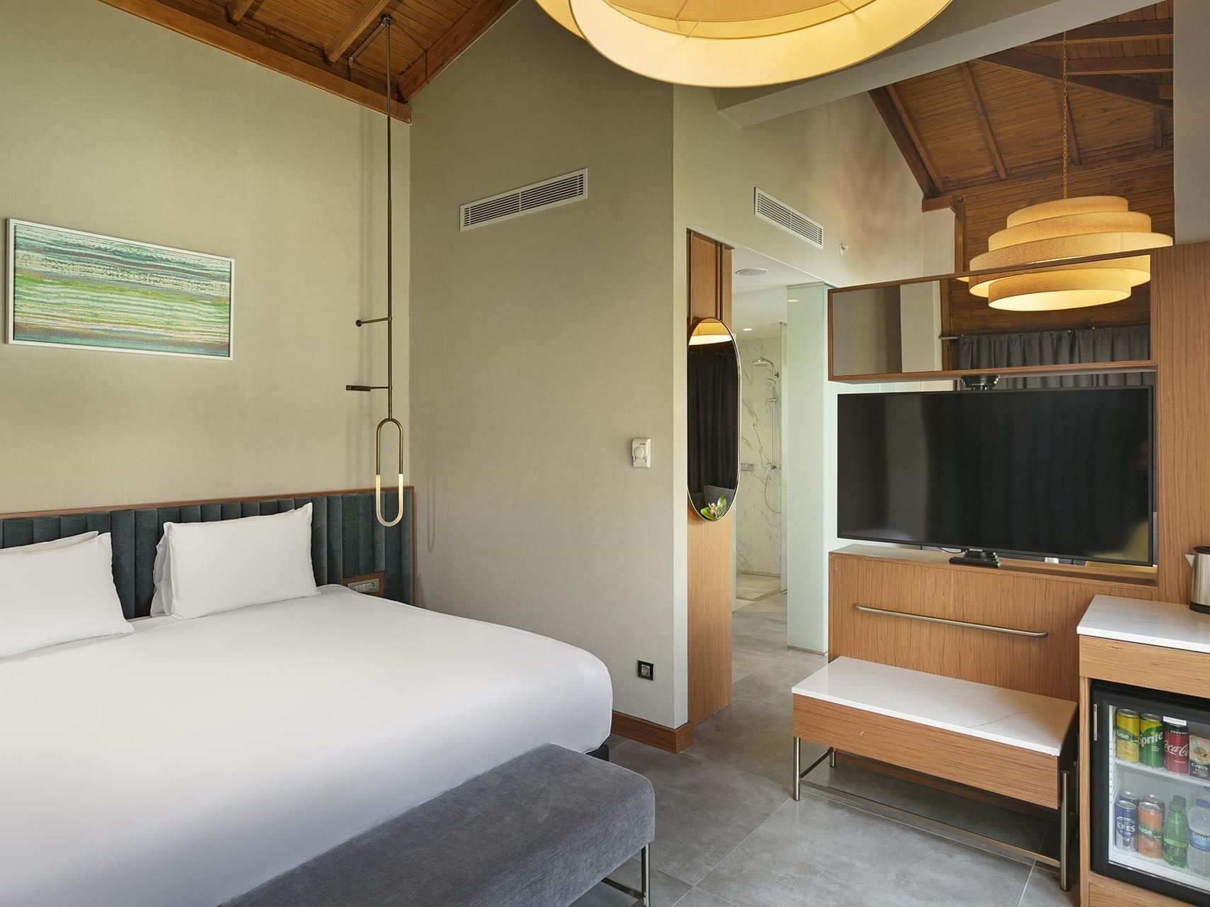 Comfy bed and TV in Bali House Garden at Titanic Deluxe Golf Belek