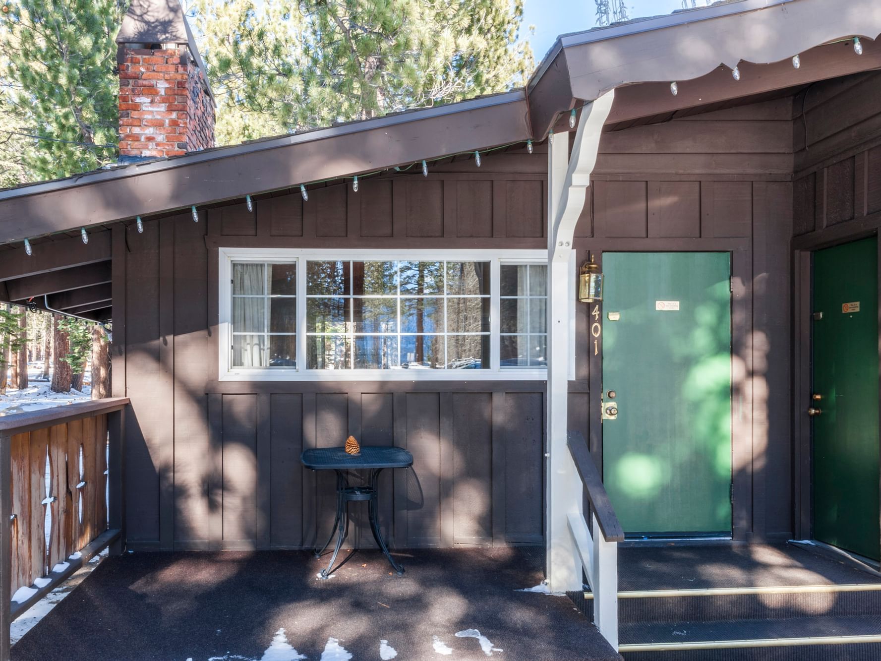 Exterior of cabin with green door at Alpenhof Lodge