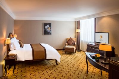 Comfy bed, lamps & TV in Premium Deluxe room at Eastin Hotels