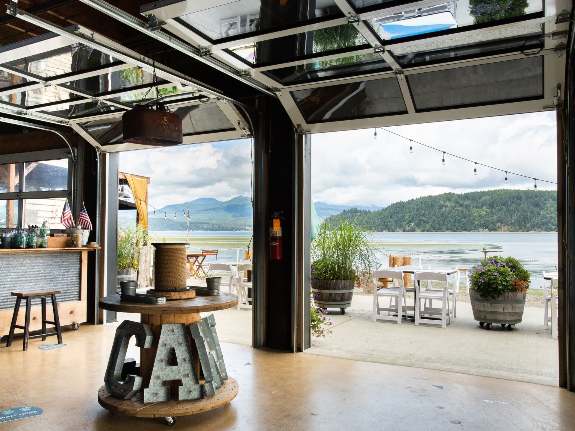 Dining tables arranged in the Private Canal Cookout at Alderbrook Resort & Spa