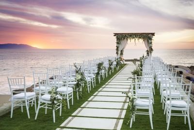 Seaside wedding dining setup at twilight at Villa Premiere Boutique Hotel & Romantic Getaway
