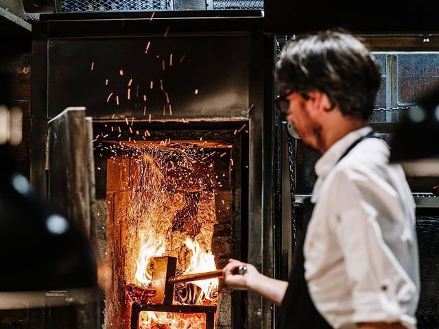 Close up on a chef setting pizza oven at Brady Hardware Lane