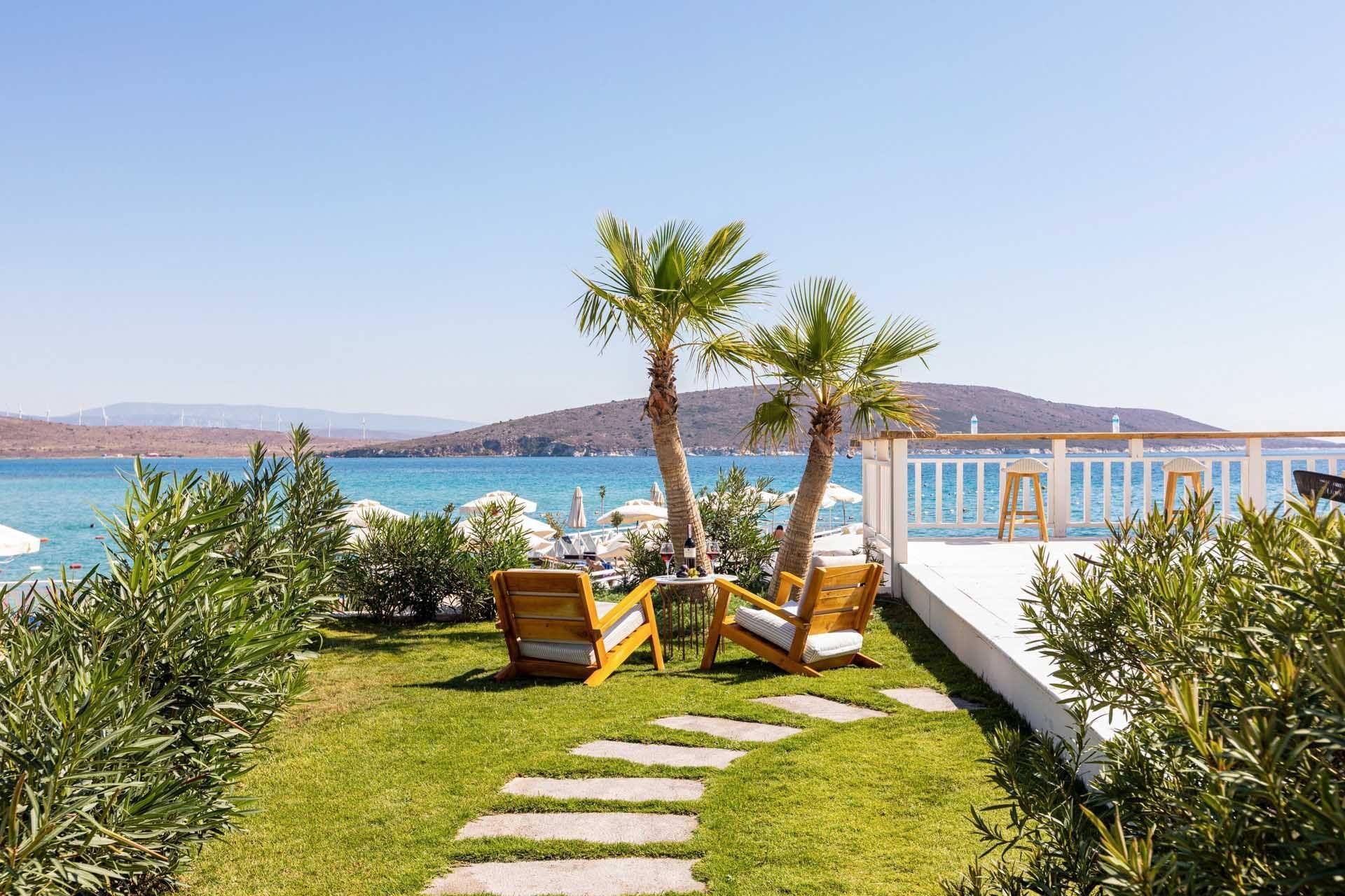 Outdoor seating area facing the sea at Design Plus Group Hotels
