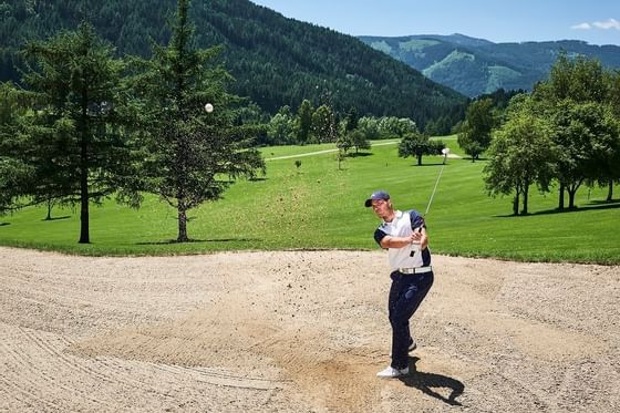 A man playing golf near Imlauer Schloss Hotel