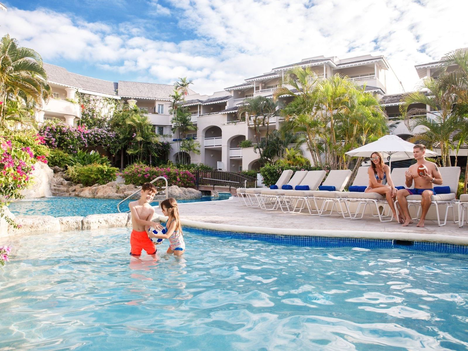 Happy family enjoying in outdoor pool at Bougainvillea Barbados