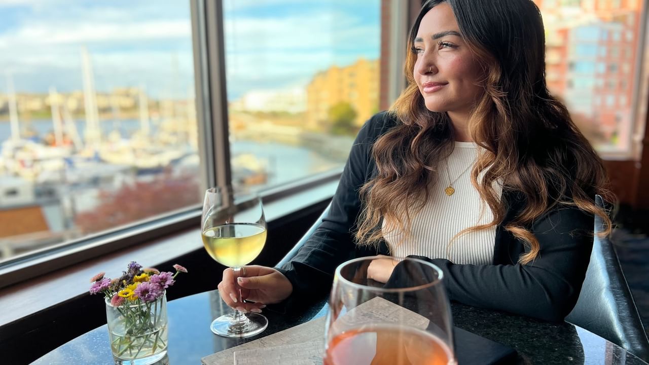Girl holding a wine glass and enjoying the view at Blue Crab