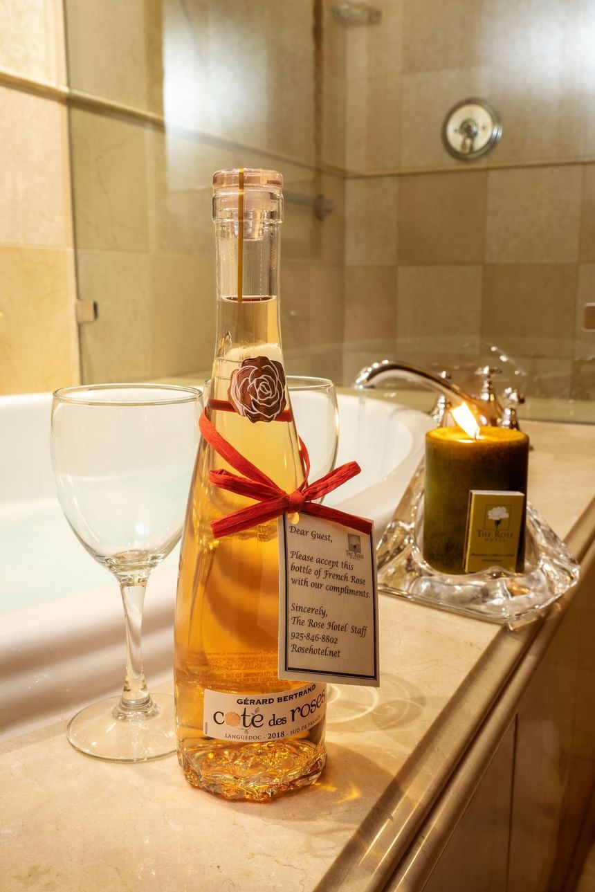 Bottle of French Rose wine with two glasses beside it, set on a marble countertop at The Rose Hotel