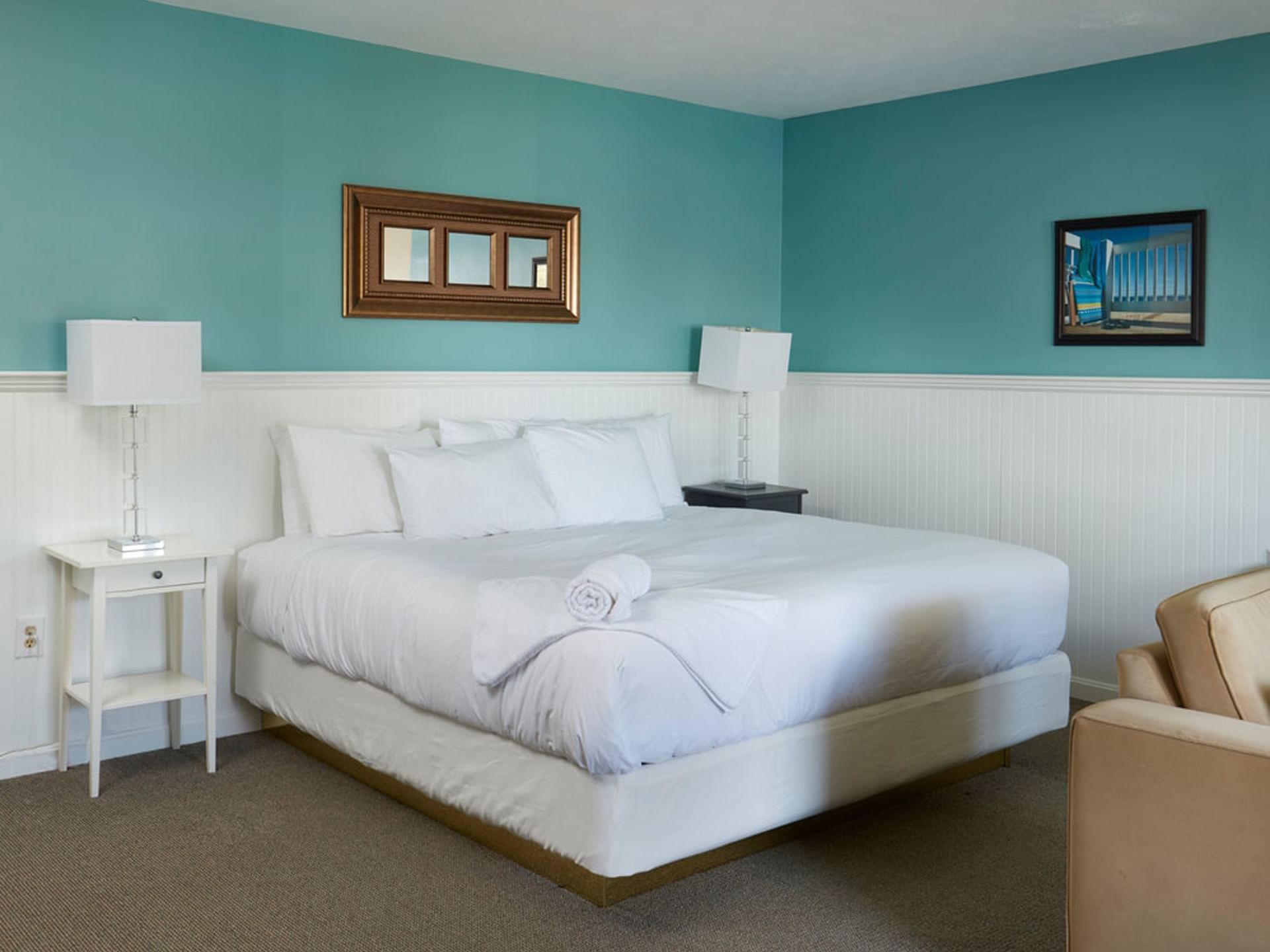 Bed with table lamps and natural light from a nearby window in Main Building Studio at Breezeway Boutique Hotel