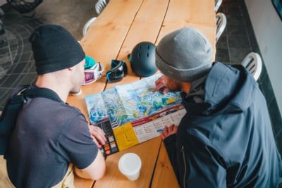 Two men reading a map at Aava Whistler Hotel