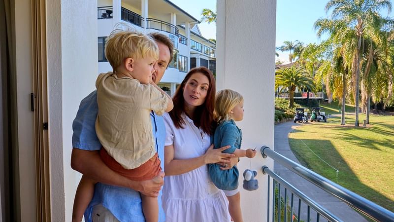Family of four enjoying balcony view at Wildlife Escape.