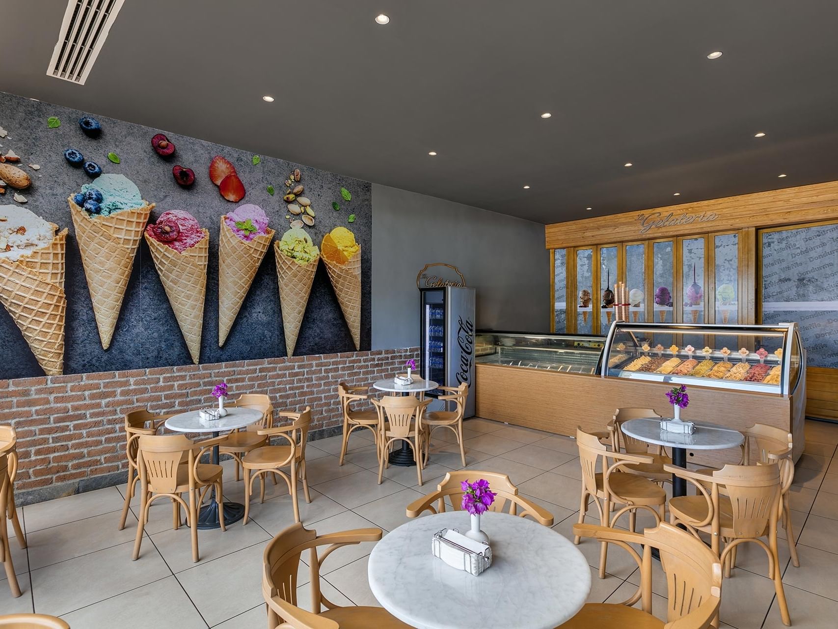 A stylish restaurant interior at Titanic Luxury Collection Bodrum, sweetened with ice cream and chocolate displays.