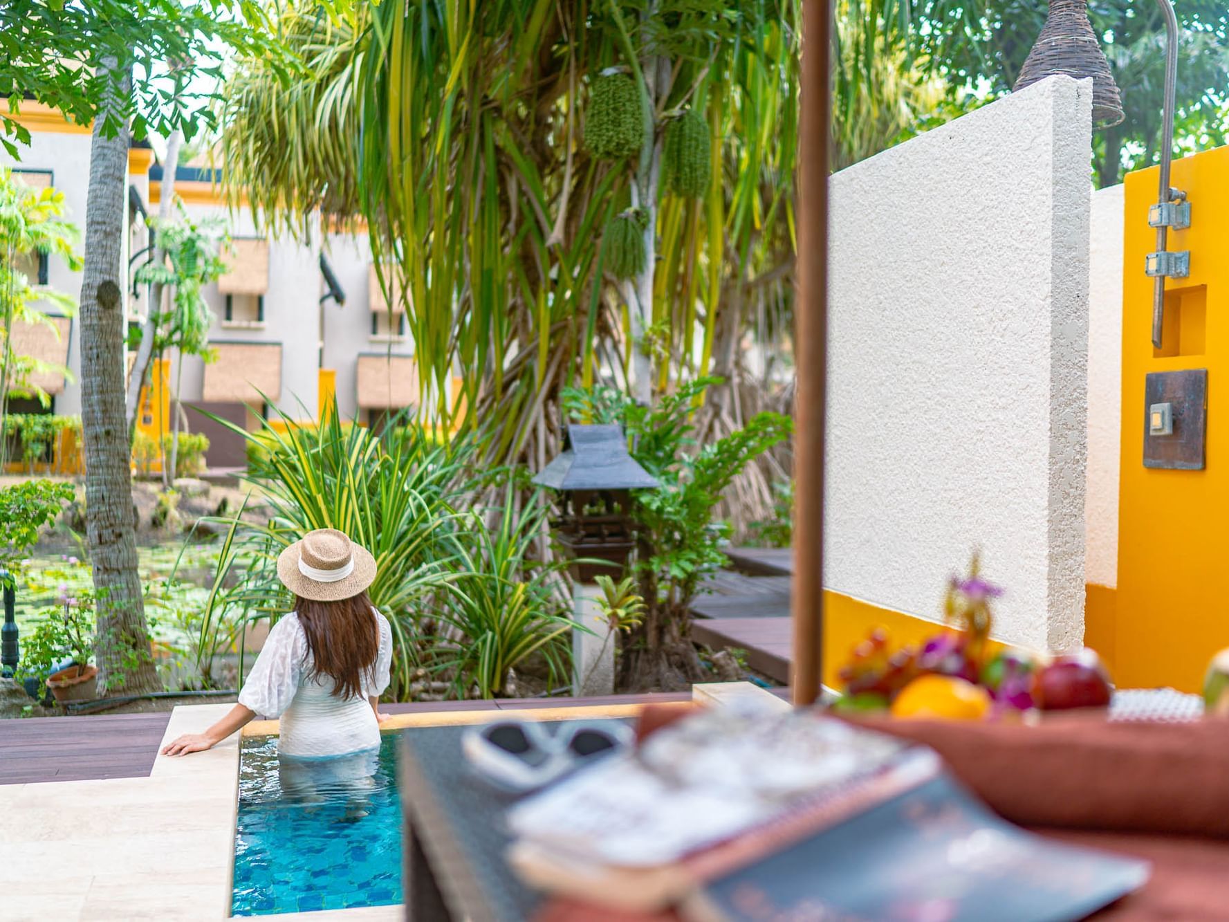 A women is chilling in the plunge pool in the Premium Garden Villa with the lagoon view
