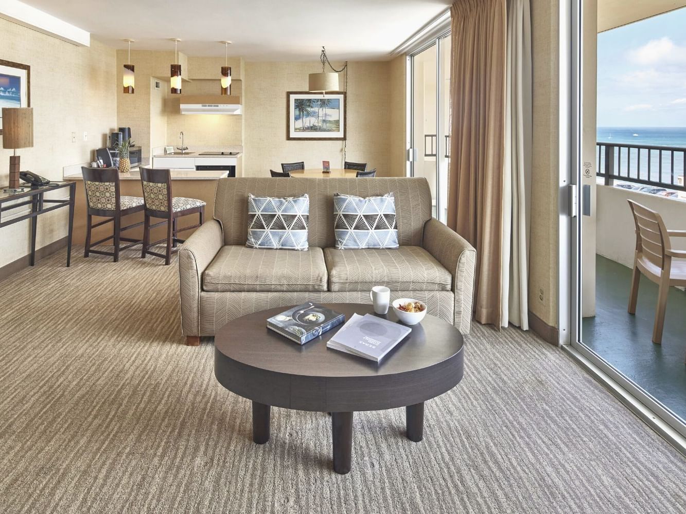 Lounge area in One Bedroom Penthouse Suite with carpeted floors at Waikiki Resort Hotel