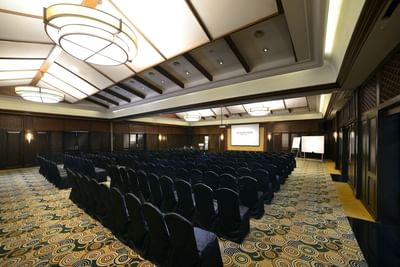 Modern Zamrud with rows of chairs, a screen, and elegant lighting at The Saujana Hotel Kuala Lumpur
