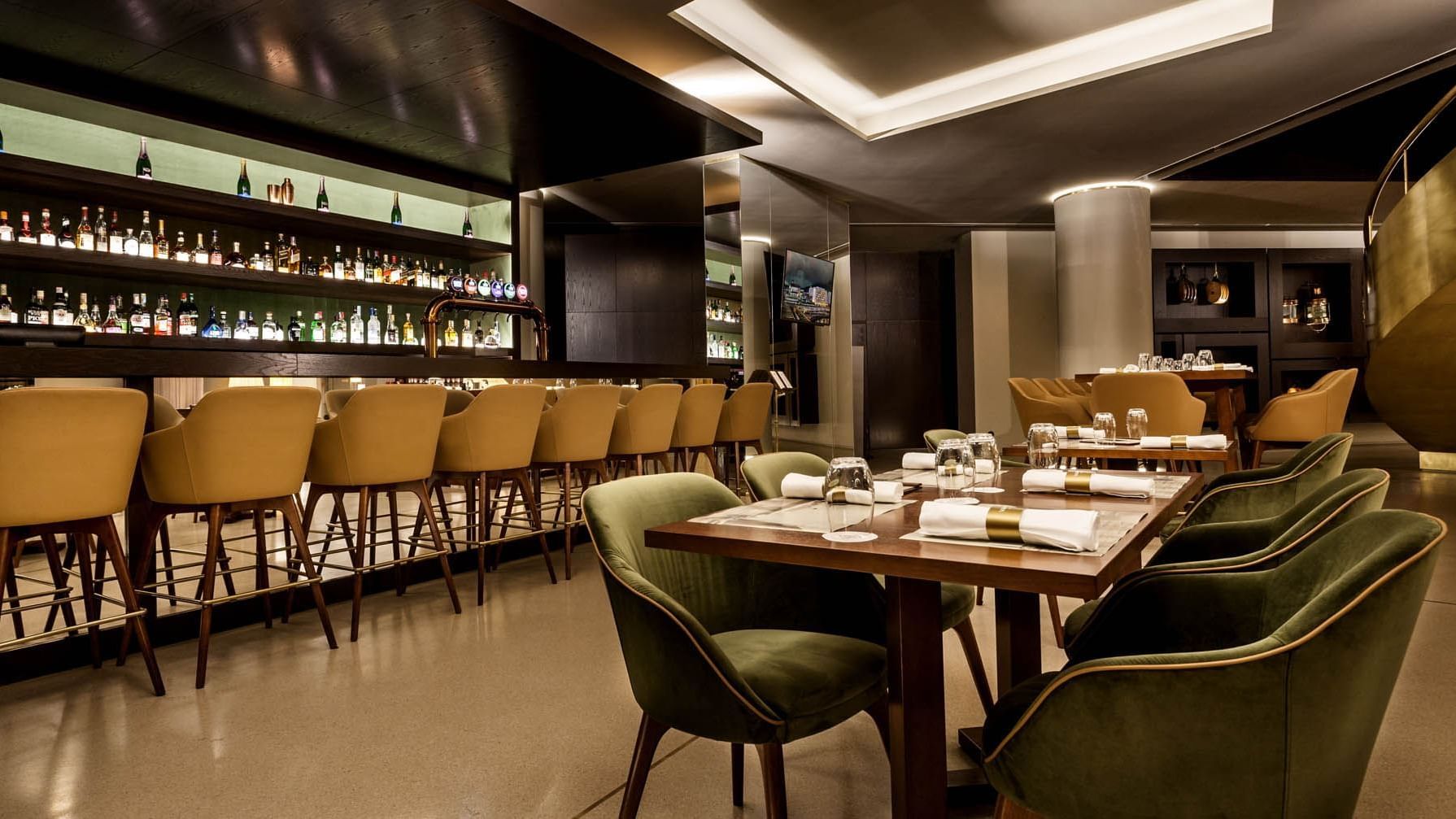 High chairs & tables by the bar counter in Vapore Bar at Grand Hotel Açores Atlântico