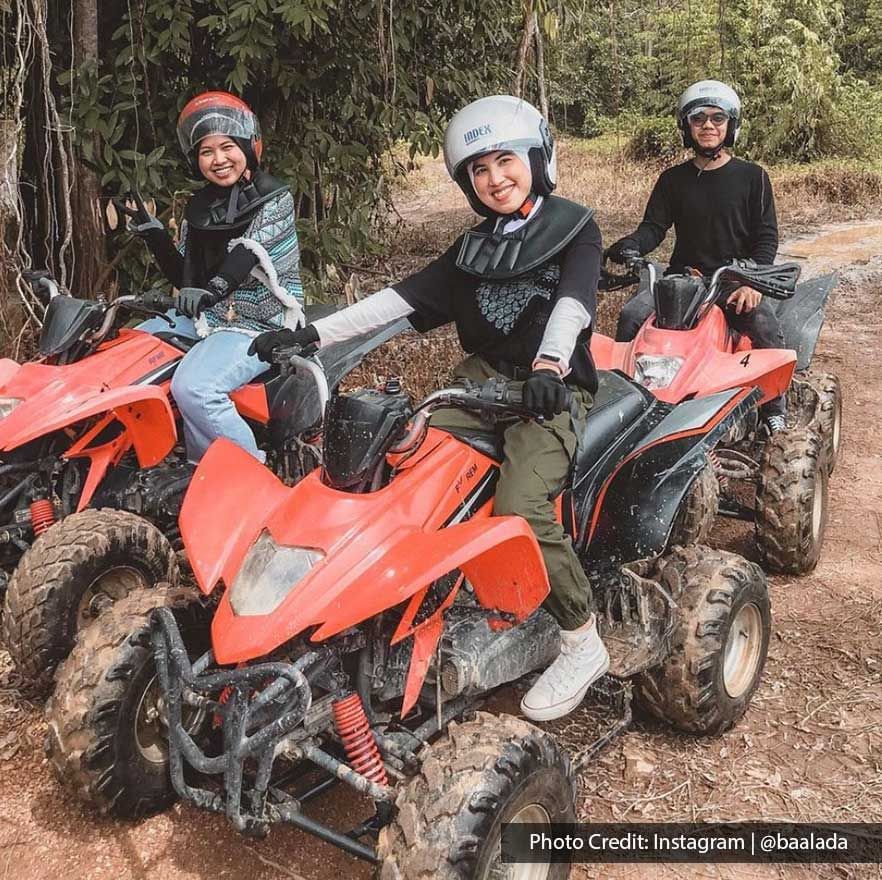 Three people riding ATVs on a dirt trail during an outdoor adventure - Lexis Port Dickson