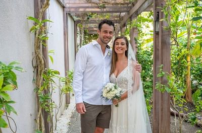 A bride and groom smile together for a photo at Bougainvillea Barbados