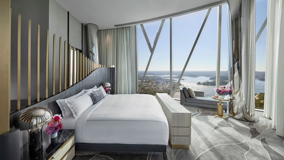 Interior of Crown Presidential Villa bedroom area with a large bed overlooking city view at Crown Hotels